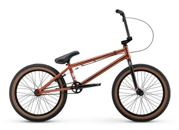 A copper-brown freestyle BMX bike with gumwall tires
