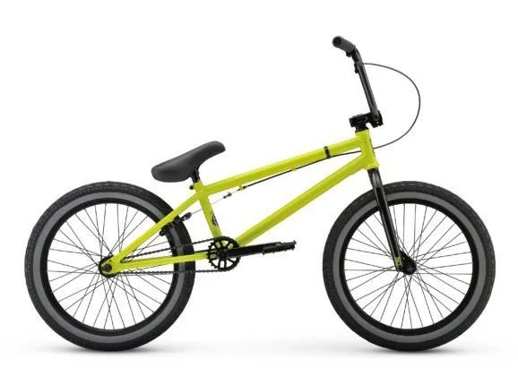 A lime yellow BMX bike with gray sidewall tires